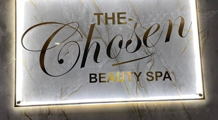 Illuminated logo of The Chosen Beauty Spa in Sandton, Gauteng, ZA showcasing elegance and luxury.