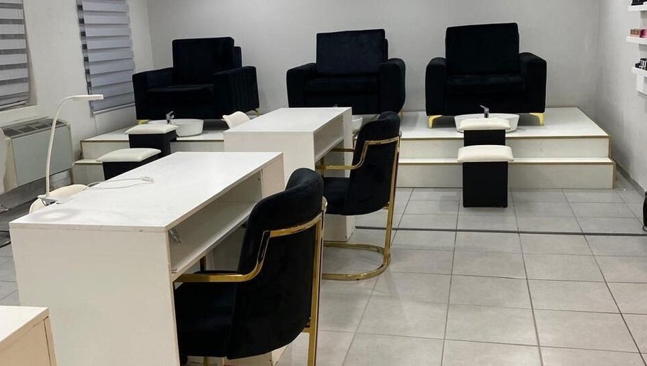 Pedicure and manicure stations at The Chosen Beauty Spa in Sandton, Gauteng, ZA, showcasing sleek black chairs.