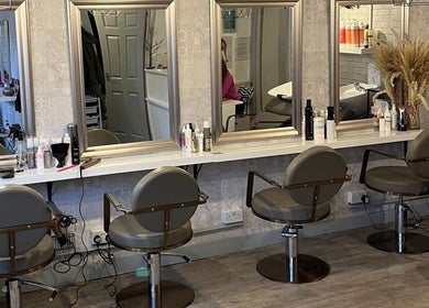 Chic salon interior at Brave, Strong, Beautiful in Edinburgh, Scotland, GB with stylish mirrors and seats.