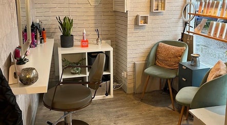 Inviting salon interior at Brave, Strong, Beautiful, Edinburgh, Scotland, GB, featuring styling chair and decor.