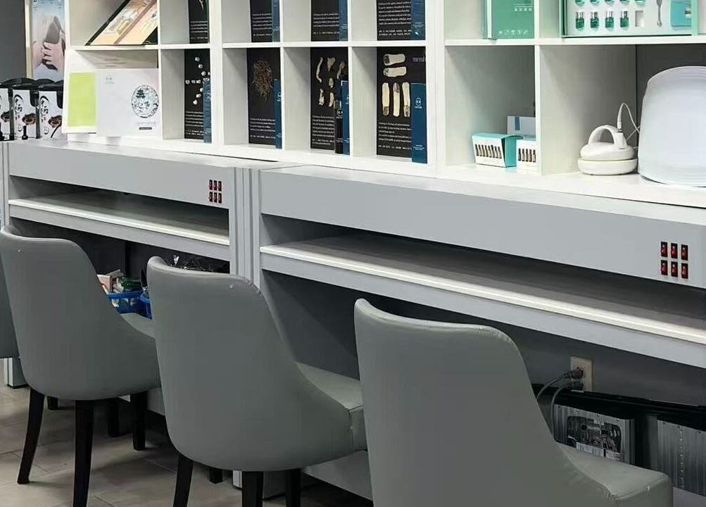 Modern nail station at Rainbow Beauty Spa in Norristown, Pennsylvania, US showcasing sleek chairs and organized shelves.