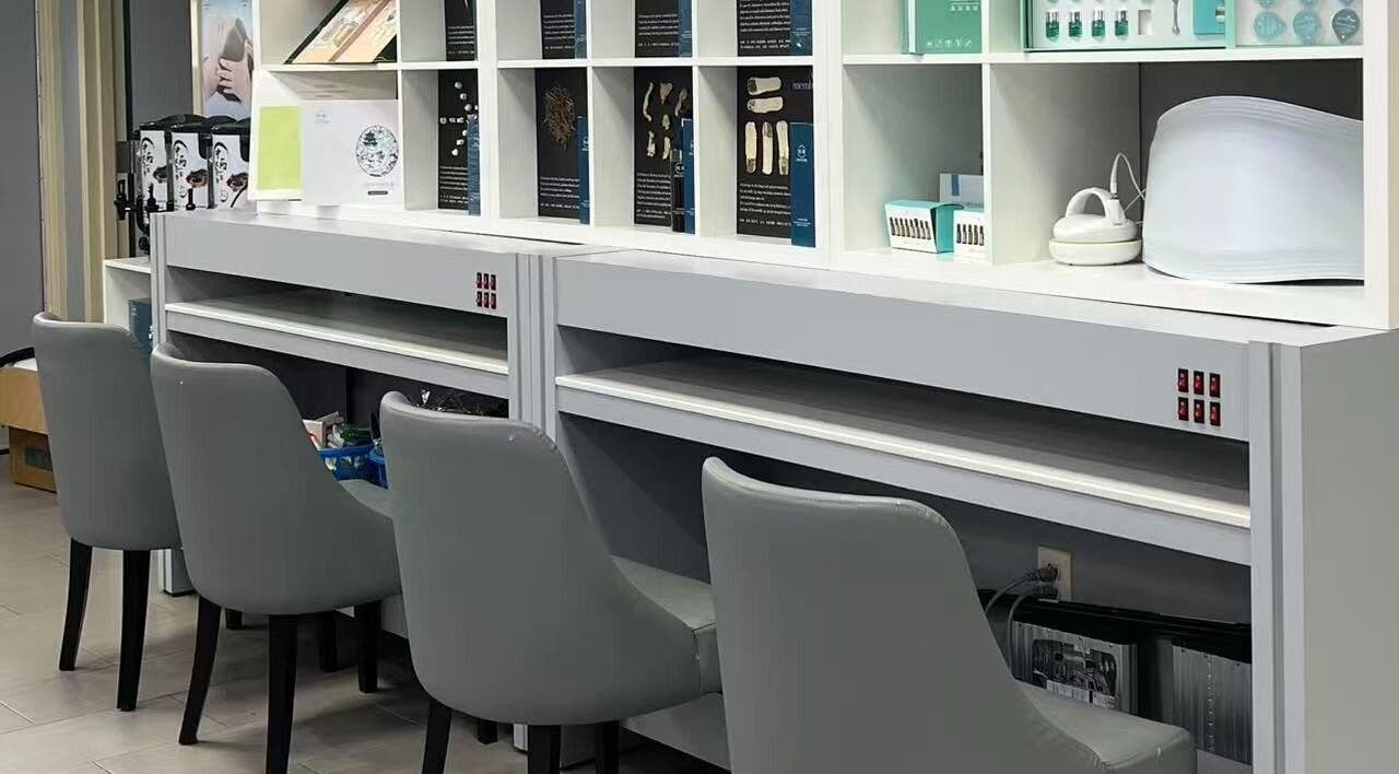Modern nail station at Rainbow Beauty Spa in Norristown, Pennsylvania, US showcasing sleek chairs and organized shelves.