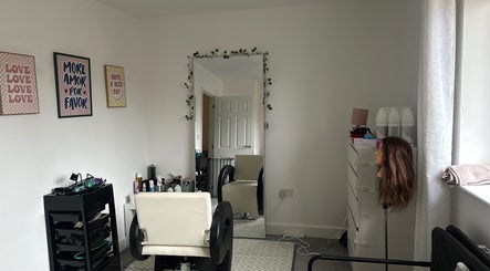 Modern salon interior at Blowoutbysophieelle, Wokingham, England, GB, featuring styling chair and wall art.
