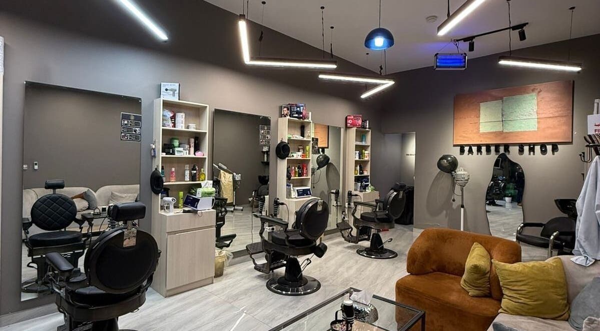 Interior of FIRST HAIR salon in Riyadh, bright modern design with stylish barber chairs and decor.