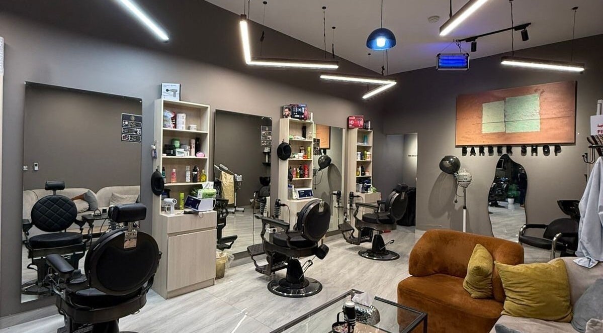 Interior of FIRST HAIR salon in Riyadh, bright modern design with stylish barber chairs and decor.