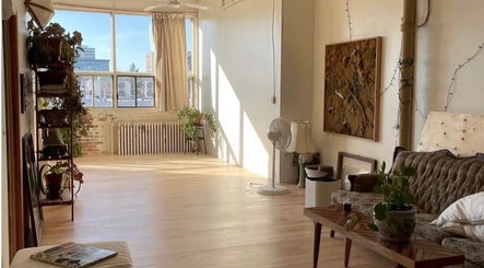 Sunlit studio at Pilatique in Montréal, Québec, CA with vintage decor and potted plants.