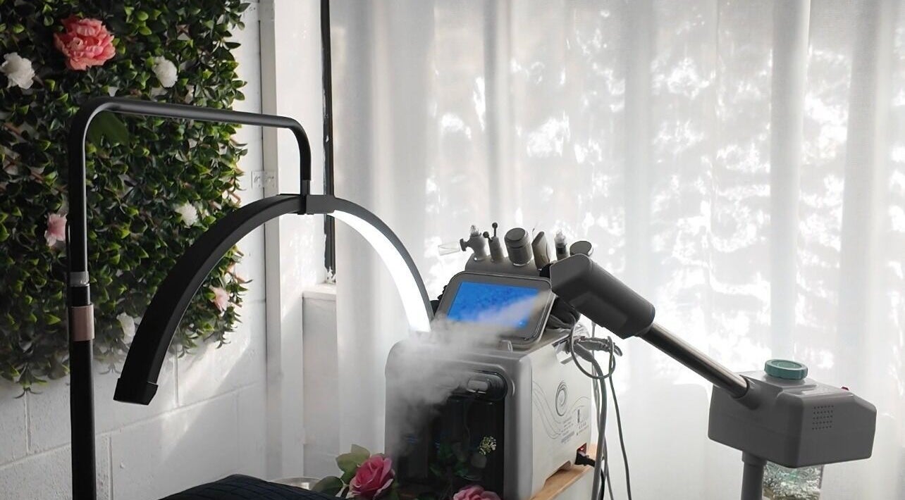 High-tech facial steam machine at Lashkara, Blacktown, New South Wales, AU, set against a floral backdrop.
