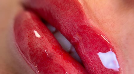 Close-up of glossy red lips at Mansi Beauty Nz, Auckland, Auckland, NZ, showcasing expert lip care.