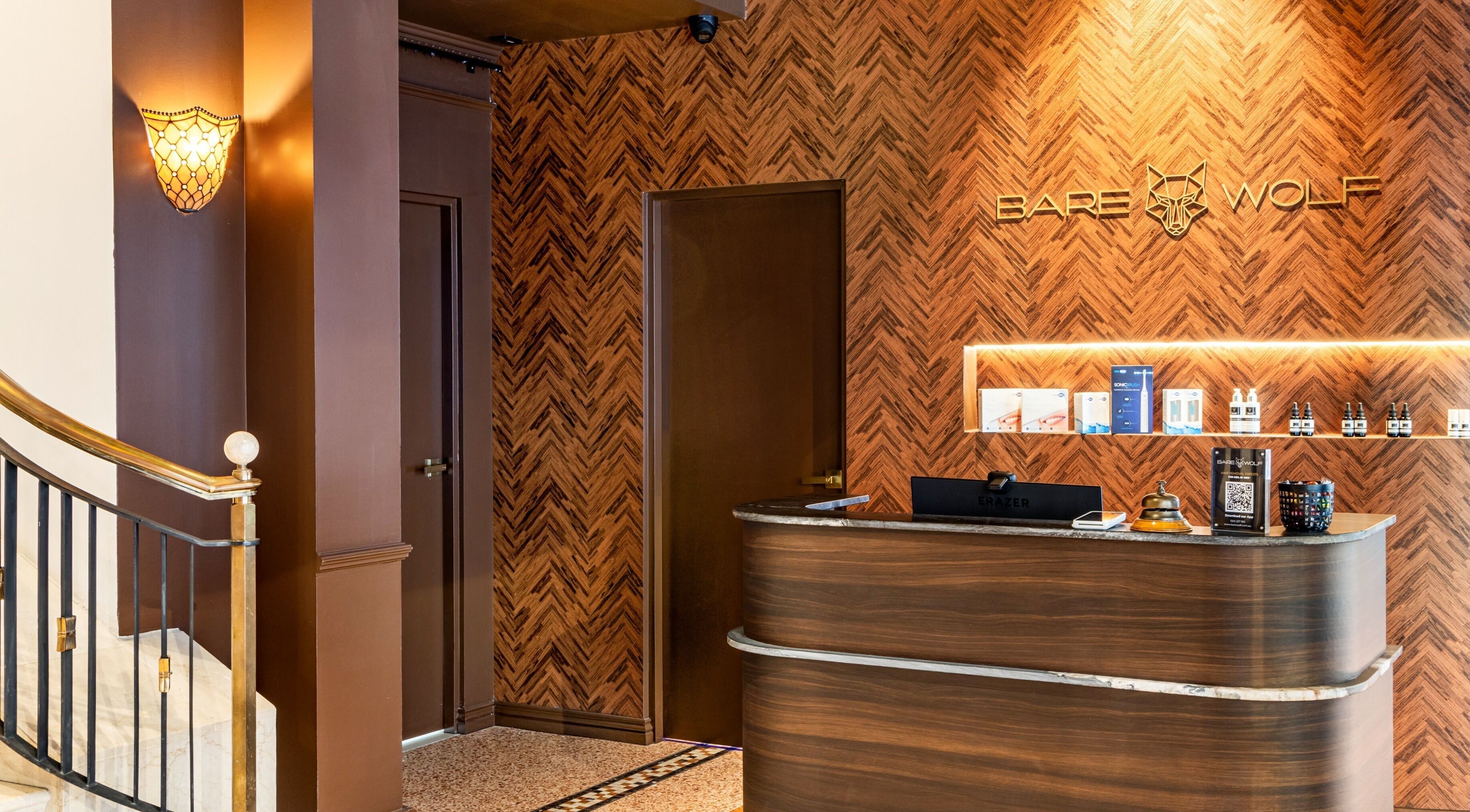 The inviting reception area of BareWolf in Sydney, New South Wales, AU, featuring elegant wood finishes and soft lighting.