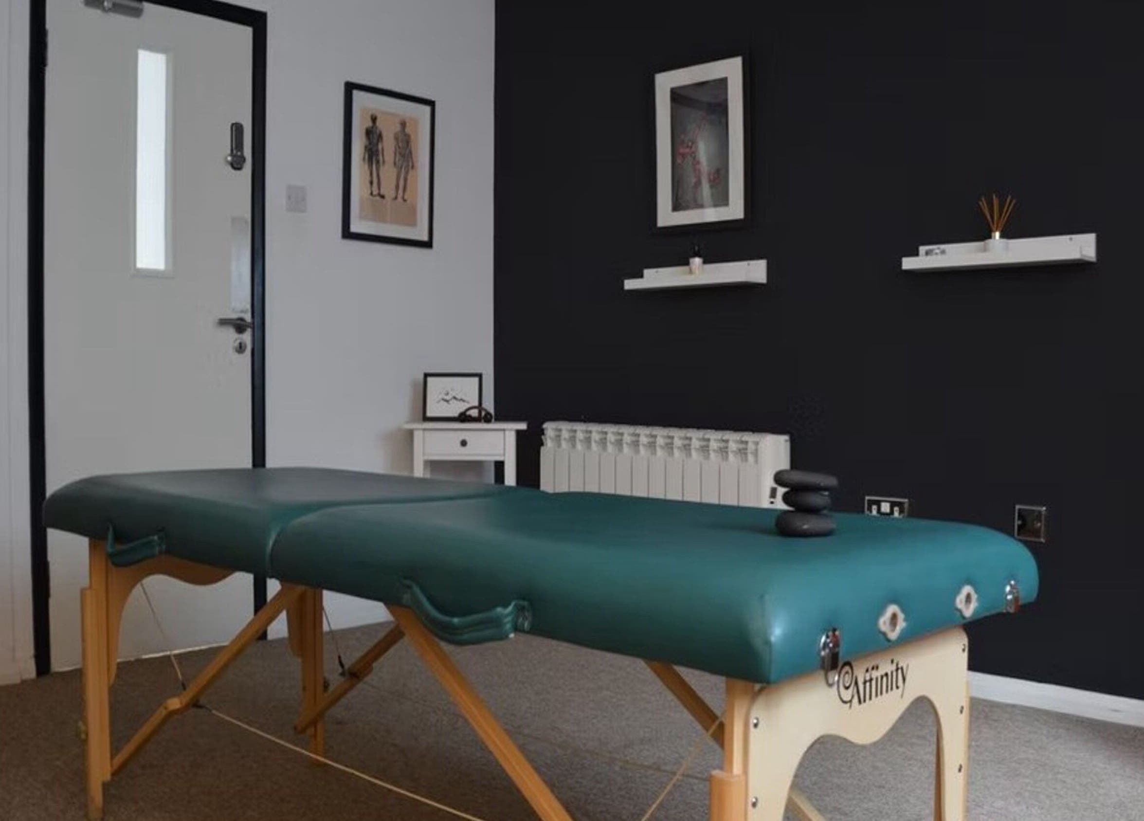 Massage table in serene room at The Unburden, Hassocks, England, GB, offering relaxing therapies.