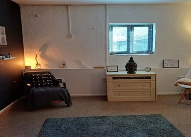 Peaceful therapy room at The Unburden in Hassocks, England, GB with warm lighting and serene decor.