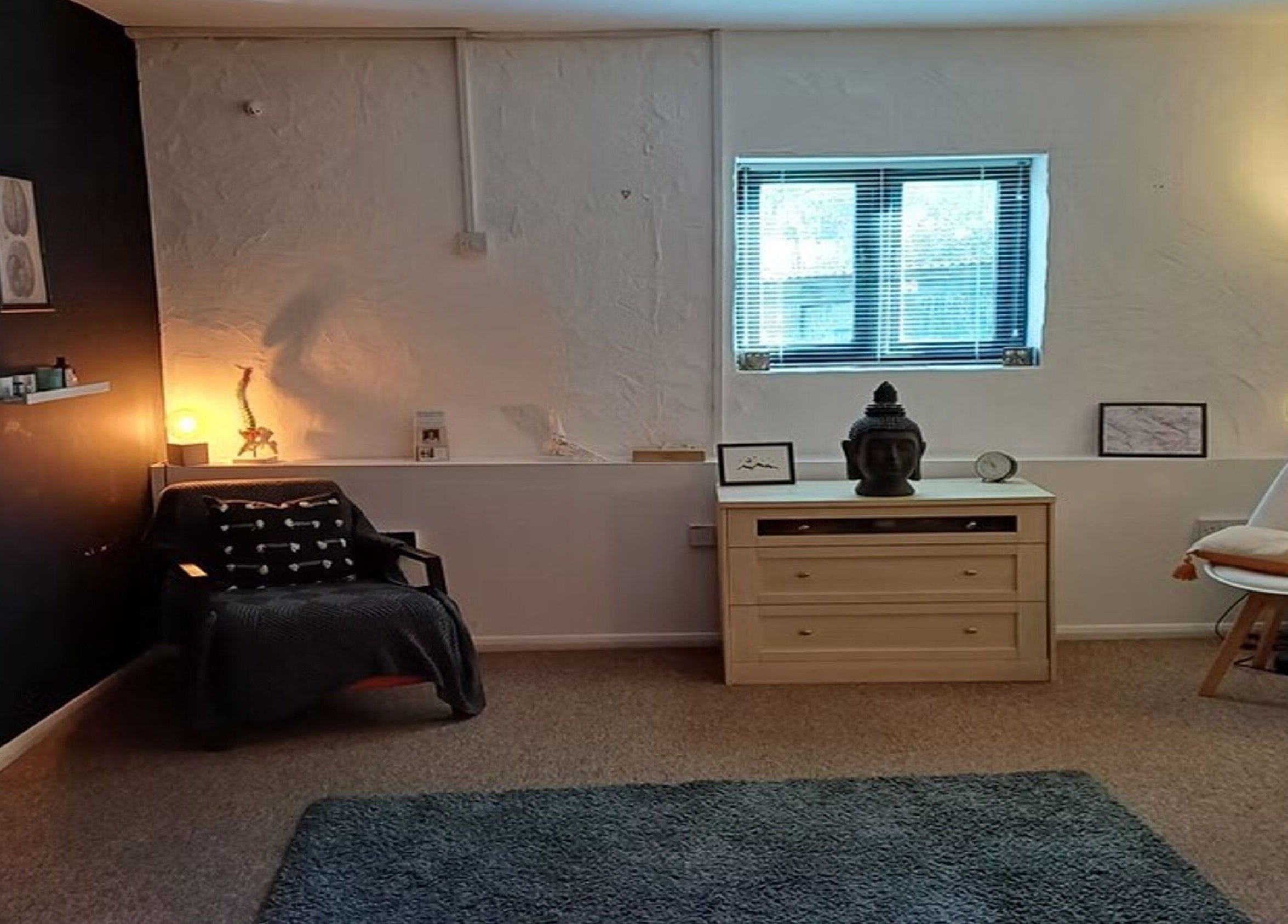 Peaceful therapy room at The Unburden in Hassocks, England, GB with warm lighting and serene decor.