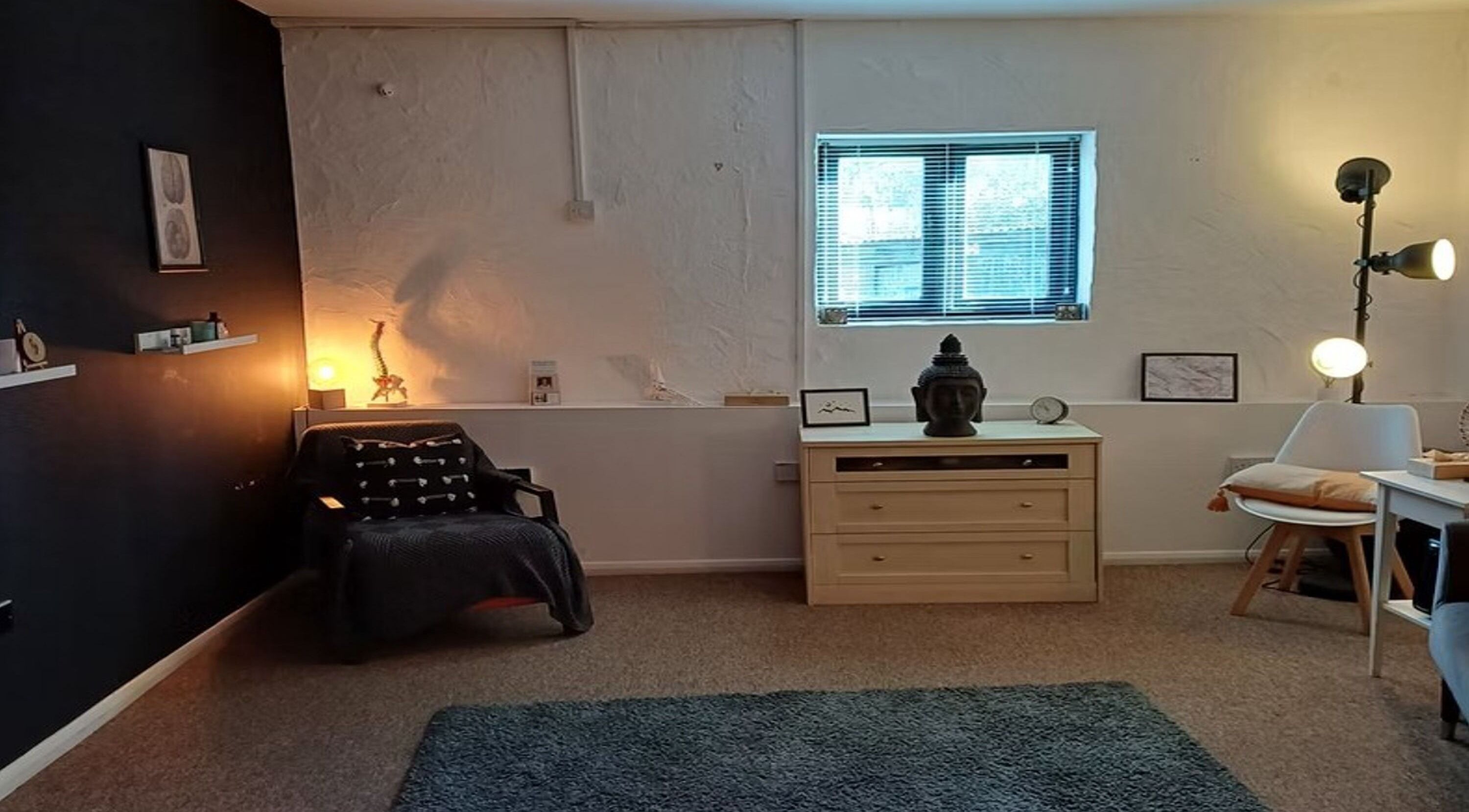 Peaceful therapy room at The Unburden in Hassocks, England, GB with warm lighting and serene decor.