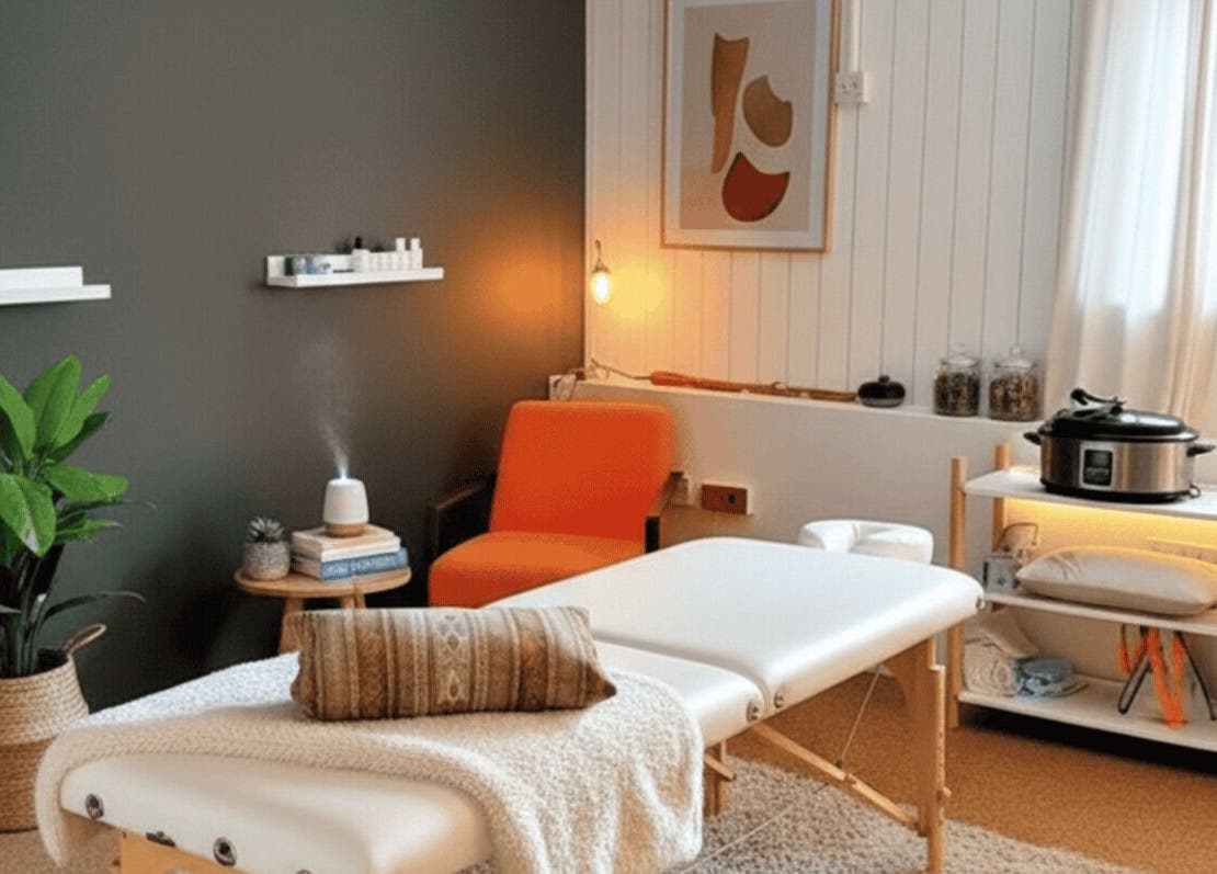 Calming therapy room at The Unburden, Hassocks, England, GB, featuring massage table and warm lighting.