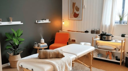 Calming therapy room at The Unburden, Hassocks, England, GB, featuring massage table and warm lighting.