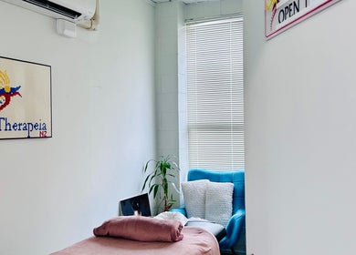 Relaxing therapy room at Therapeia Limited, Auckland, Auckland, NZ with cozy seating and soft lighting.