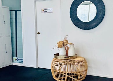 Therapeia Limited entrance in Auckland, NZ with elegant decor and mirror reflecting calm ambiance.