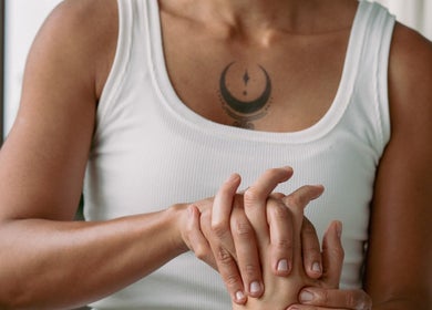 Therapist performing hand massage at Bruna Monteiro Yoga and Holistic Therapies, Beverly Hills, California, US.