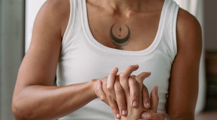 Therapist performing hand massage at Bruna Monteiro Yoga and Holistic Therapies, Beverly Hills, California, US.