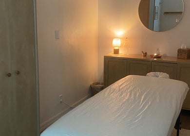 Tranquil massage room at Bruna Monteiro Yoga and Holistic Therapies, Beverly Hills, California, US, with soft lighting.