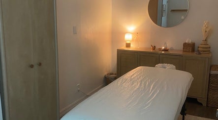 Tranquil massage room at Bruna Monteiro Yoga and Holistic Therapies, Beverly Hills, California, US, with soft lighting.