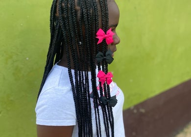 Braided hairstyle with pink bows at Beautyparlourbds, Bridgetown, Saint Michael, BB.