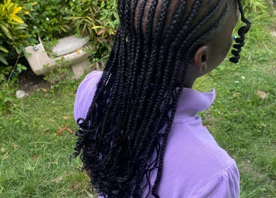 Elegant braids at Beautyparlourbds, Bridgetown, Saint Michael, BB, with lush garden background.