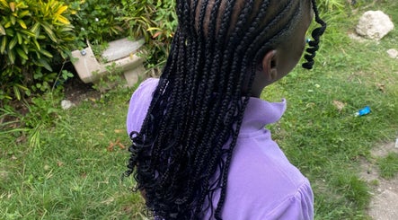 Elegant braids at Beautyparlourbds, Bridgetown, Saint Michael, BB, with lush garden background.
