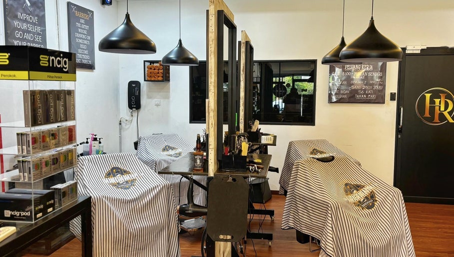 Interior view of ORAMA Barbershop in Kuala Lumpur with stylish decor and well-equipped barber stations.