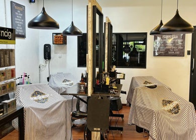 Interior view of ORAMA Barbershop in Kuala Lumpur with stylish decor and well-equipped barber stations.