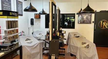 Interior view of ORAMA Barbershop in Kuala Lumpur with stylish decor and well-equipped barber stations.