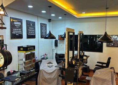 Interior of ORAMA Barbershop in Kuala Lumpur, highlighting modern decor and barber chairs.