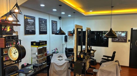 Interior of ORAMA Barbershop in Kuala Lumpur, highlighting modern decor and barber chairs.