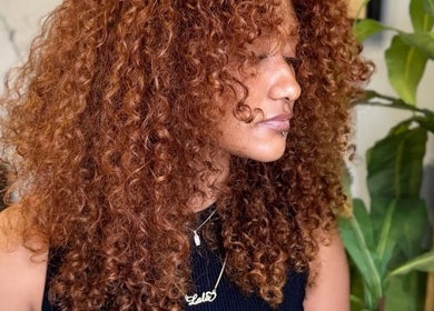 Woman with curly auburn hair at Barbara SPA Queen in Dallas, Texas, US.