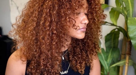 Woman with curly auburn hair at Barbara SPA Queen in Dallas, Texas, US.