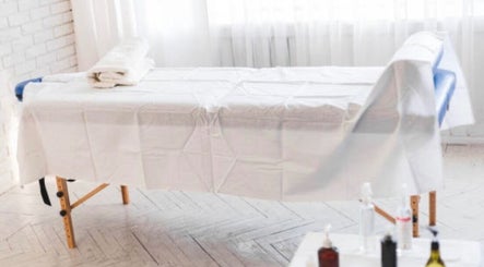 Massage table at Nicolai Holistic, London, England, GB, set for relaxation and wellness treatments.