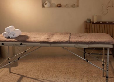 Relaxing massage table setup at Nicolai Holistic in London, England, GB. Experience tranquility and wellness here.
