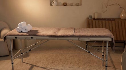 Relaxing massage table setup at Nicolai Holistic in London, England, GB. Experience tranquility and wellness here.