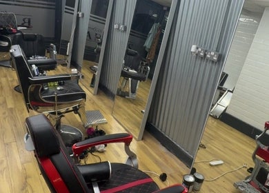 Interior of court_street_barbers in Enniscorthy, County Wexford, IE with stylish black chairs and mirrors.