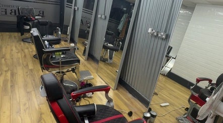 Interior of court_street_barbers in Enniscorthy, County Wexford, IE with stylish black chairs and mirrors.