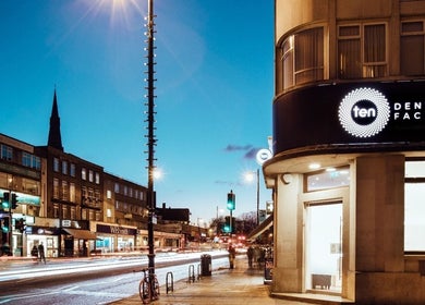 Evening view of Ten Dental + Facial in London, England, GB with vibrant street lights.