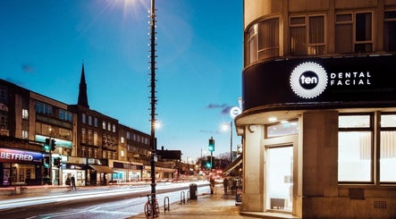 Evening view of Ten Dental + Facial in London, England, GB with vibrant street lights.