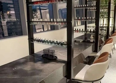 Nail Station interior in Doha, Doha Municipality, QA, showcasing elegant nail polish displays and seating.