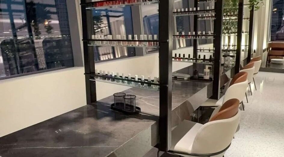 Nail Station interior in Doha, Doha Municipality, QA, showcasing elegant nail polish displays and seating.