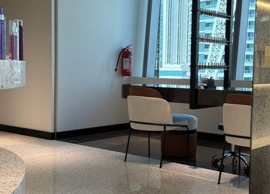 Chic interior of Nail Station, Doha, Doha Municipality, QA, featuring modern seating and elegant products.