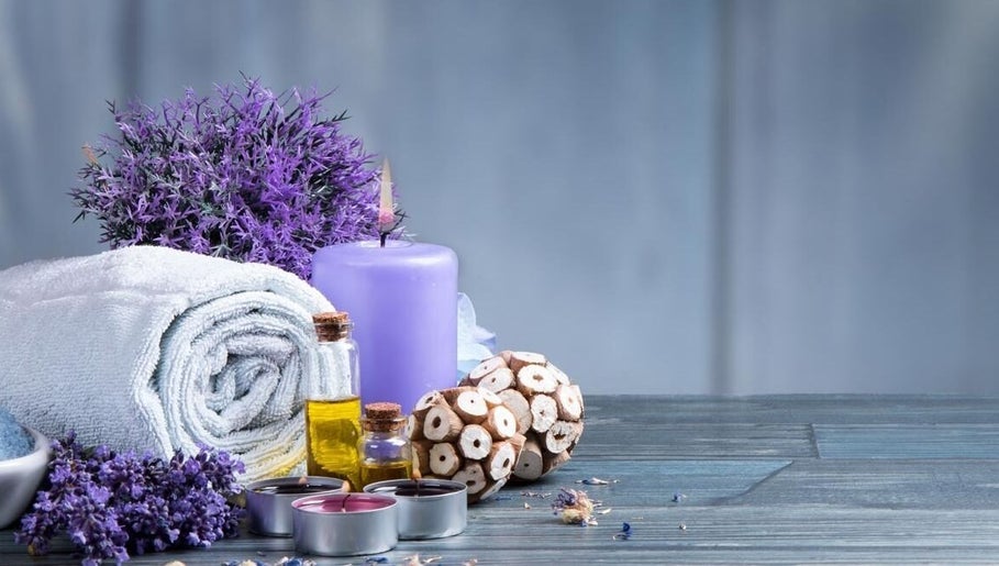 Lavender spa arrangement at Relaxation Foot Spa in Puyallup, Washington, US, featuring towels, candles, and oils.