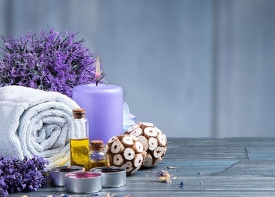 Lavender spa arrangement at Relaxation Foot Spa in Puyallup, Washington, US, featuring towels, candles, and oils.
