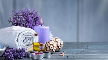 Lavender spa arrangement at Relaxation Foot Spa in Puyallup, Washington, US, featuring towels, candles, and oils.