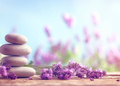 Stacked stones and lavender representing Relaxation Foot Spa, Puyallup, Washington, US, evoke serenity.