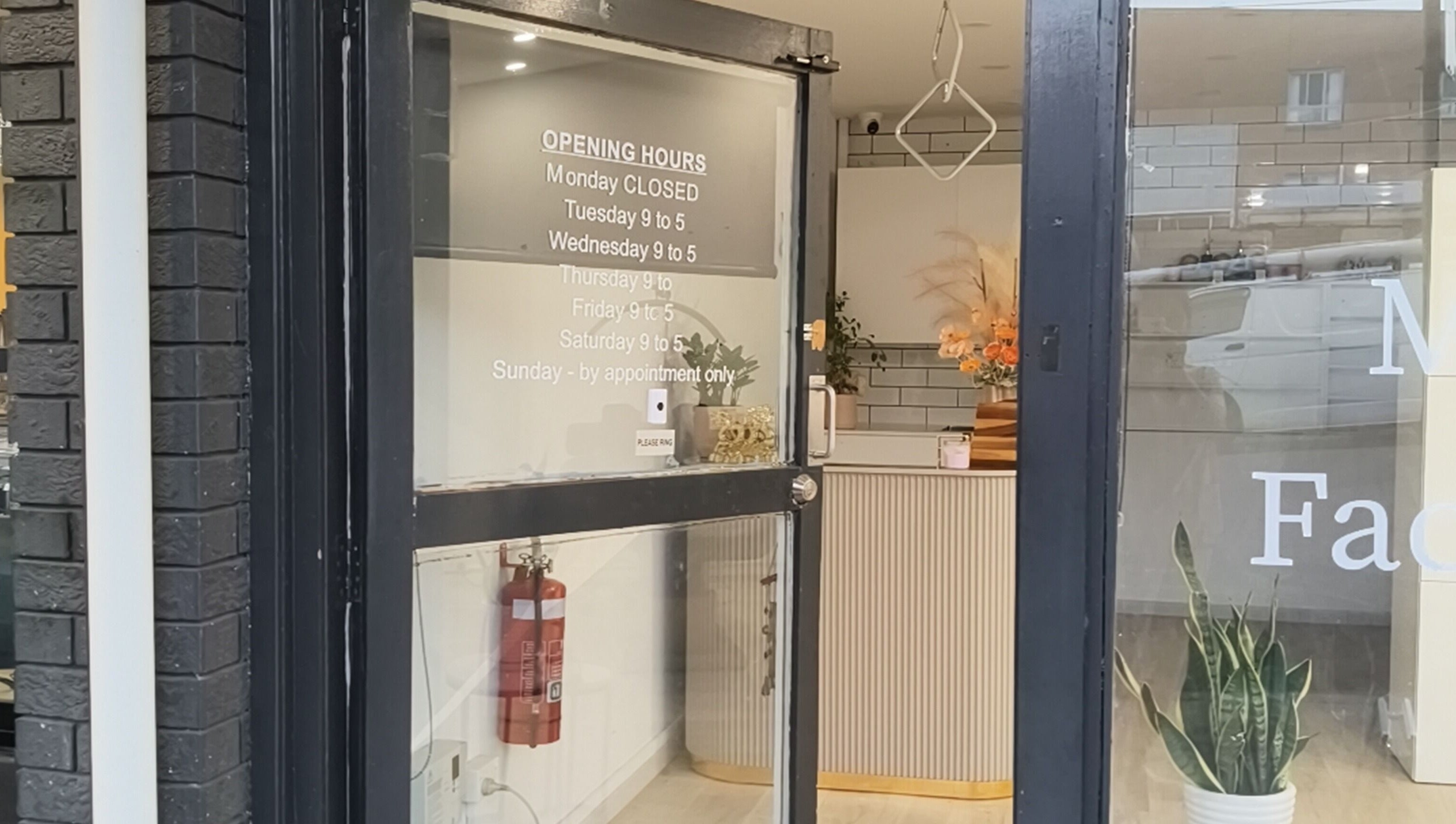 Front entrance of Zenith Spa, Regents Park, New South Wales, AU with welcoming decor and opening hours displayed.